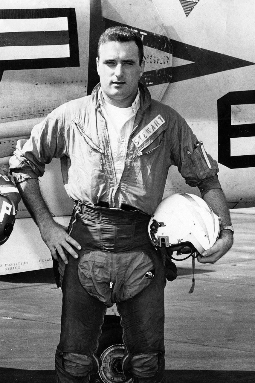 Lt. Stewart in flight gear beside his aircraft